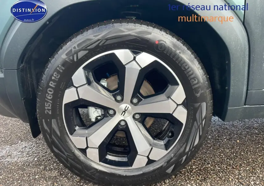 Gros plan sur la roue avant droite du Dacia Duster 2026 vert cèdre avec jante alliage noire et grise.