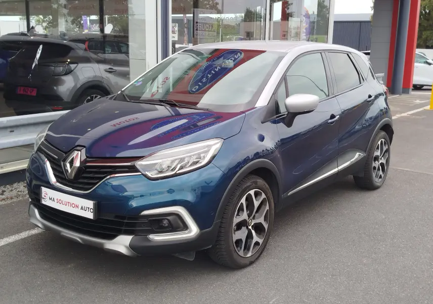 Renault Captur 2018 bleu marine fumé avec toit gris platine, vue 3/4 avant droit, jantes alliage bicolores.