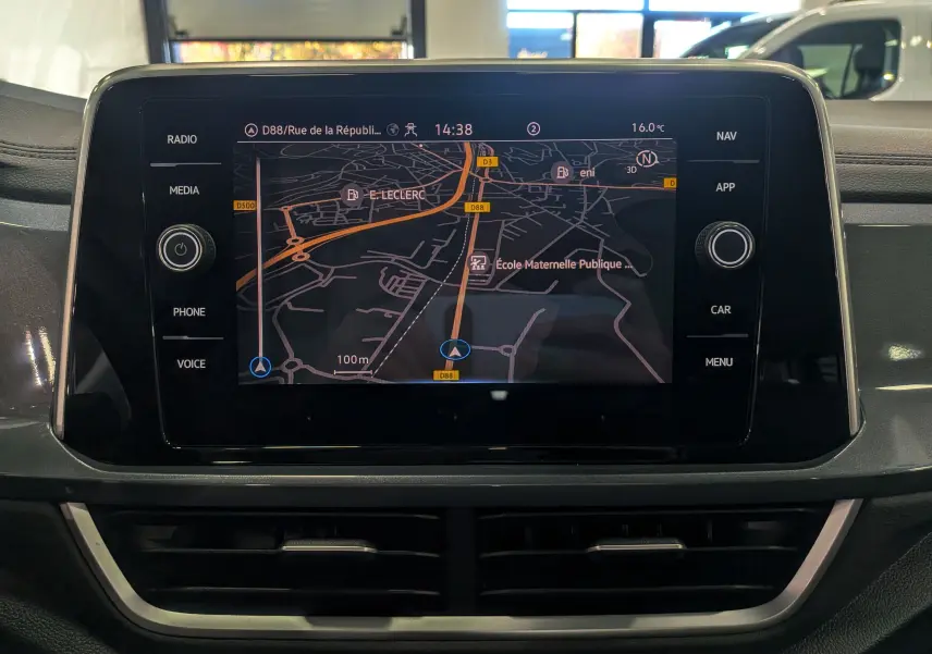 Écran tactile central du Volkswagen T-Roc 2024 affichant la navigation avec carte et commandes multimédia autour.