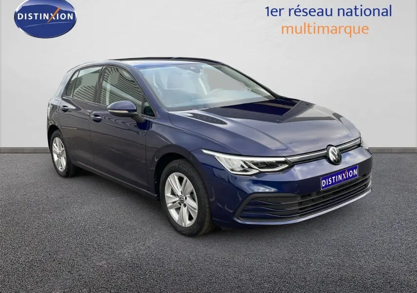 Volkswagen Golf VIII bleu lapiz metal en 3/4 avant droit, avec jantes alliage et phares LED allumés.