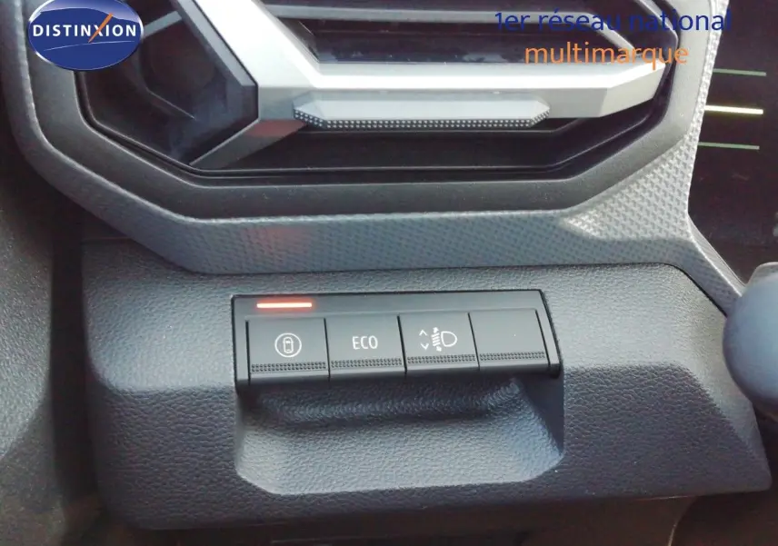 Gros plan sur les commandes de tableau de bord du Dacia Duster TCE MHEV 140ch Journey, boutons ECO et phares visibles.