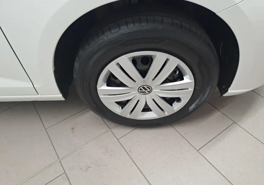 Gros plan sur la roue avant gauche blanche candy du Volkswagen Caddy Cargo Maxi 2026 avec enjoliveur et pneu Hankook.