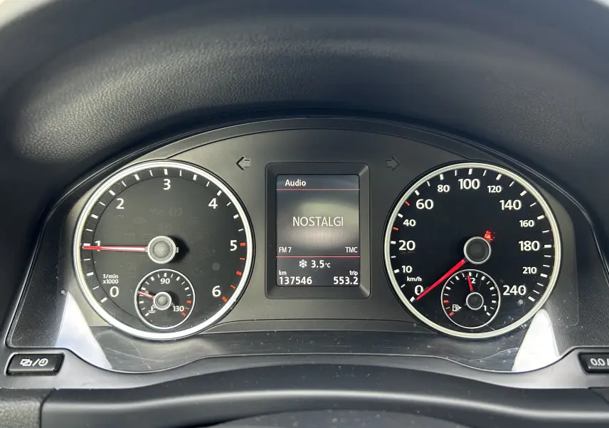 Tableau de bord du Volkswagen Tiguan 2015 affichant compte-tours, vitesse, température extérieure et radio FM.