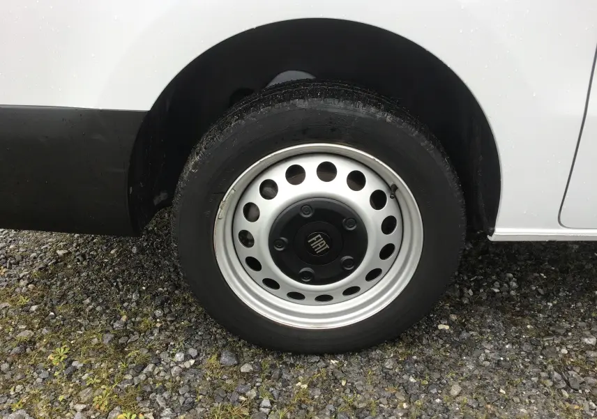 Gros plan sur la roue avant droite blanche du FIAT Scudo Fourgon 2024 avec jante acier et logo central noir.