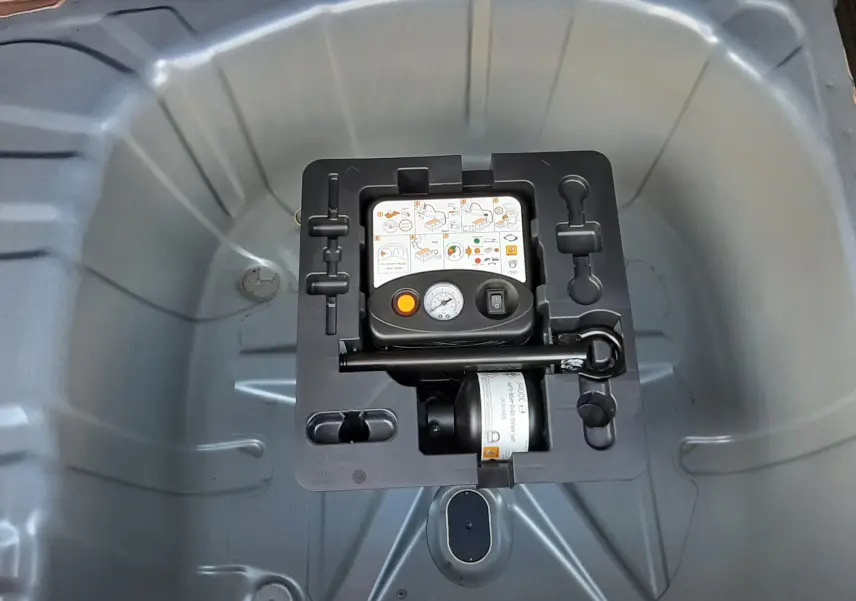 Gros plan sur le compresseur de roue dans le coffre du Renault Captur II Ph.2 TCE 90CH TECHNO 2025 bleu Iron.