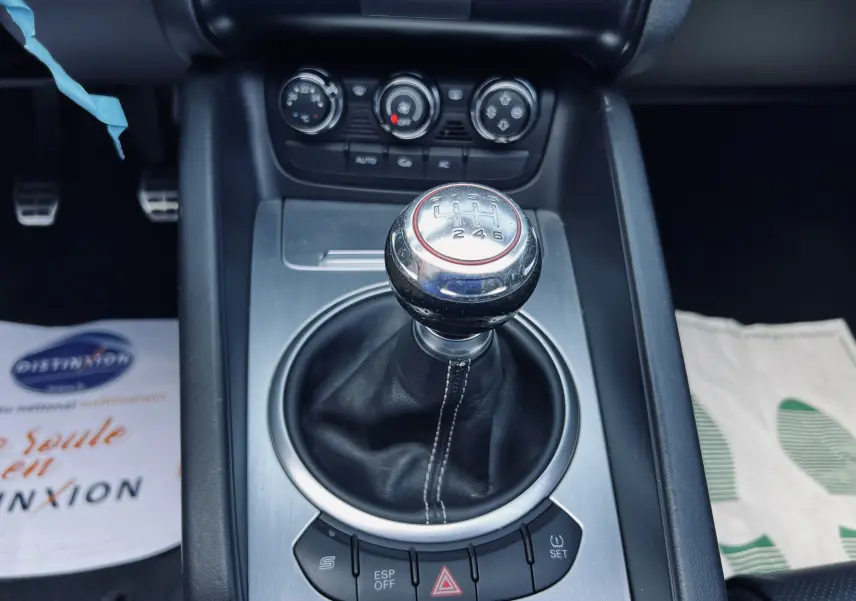 Le levier de vitesses manuel en gros plan au centre de la console d'une Audi TT RS Roadster blanche de 2009.