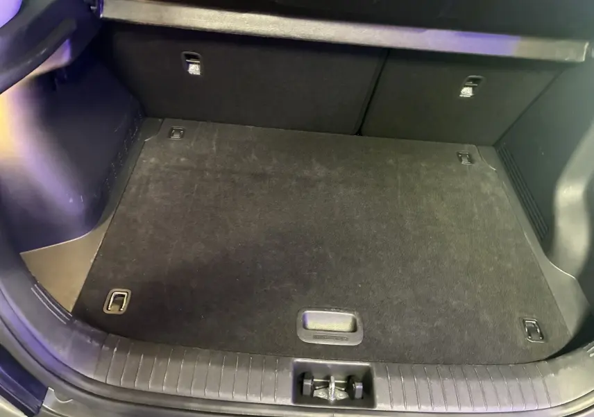 Coffre ouvert vu de dessus d'un Hyundai Kona noir 2023, montrant un espace de chargement propre et bien fini.