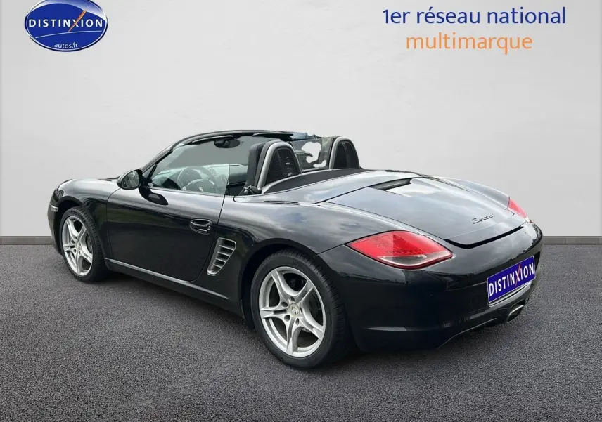 Porsche Boxster 987 2.9 noir vue 3/4 arrière droit, cabriolet avec jantes alu 17 pouces et feux arrière LED.