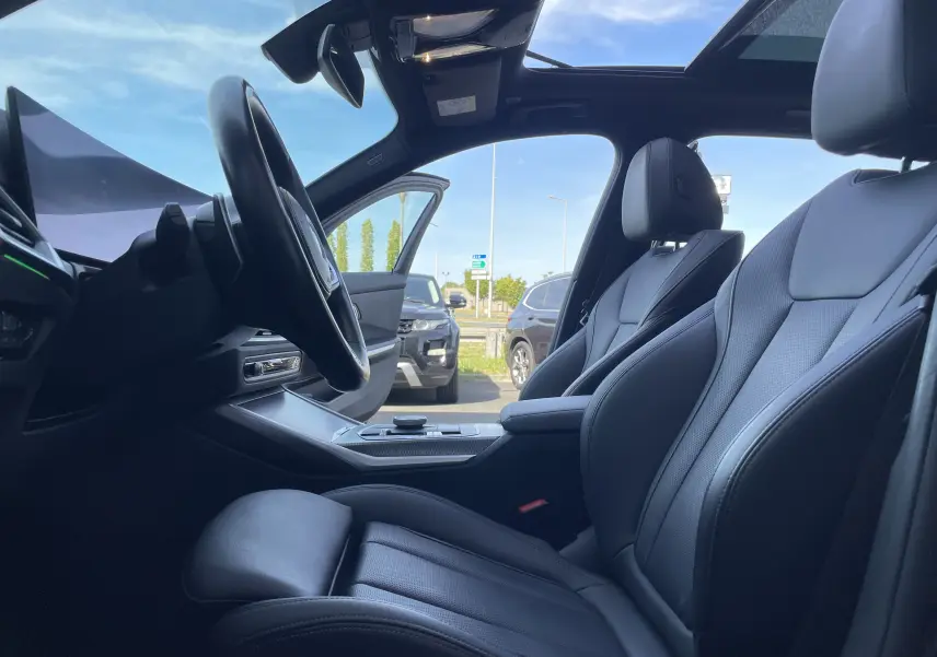 Intérieur noir cuir de la BMW Série 3 Touring G21 XDrive 190 M Sport, vue côté conducteur avec toit ouvrant panoramique.
