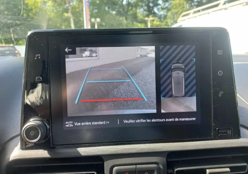 Écran central du Toyota Proace City Verso 2023 montrant la caméra de recul avec lignes de guidage en bleu et rouge.
