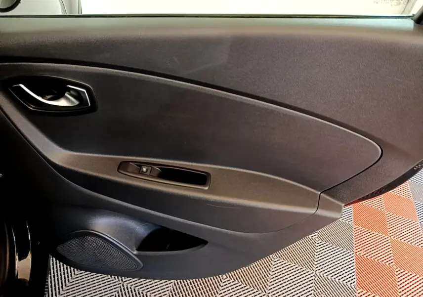 Intérieur montrant la porte côté conducteur du Renault Captur noir 2018 avec poignée et commande de vitre électrique.