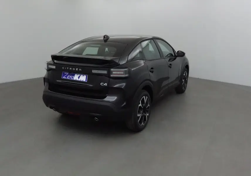 Citroën C4 noire vue 3/4 arrière droit dans un studio, avec feux arrière LED et jantes alliage noires.