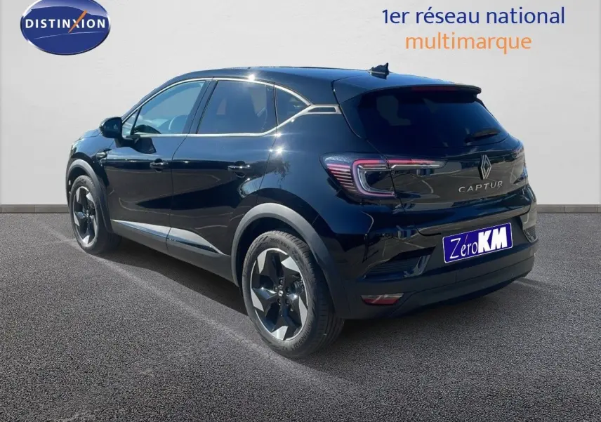 Vue 3/4 arrière droite d'un Renault Captur noir étoile métal 2025, hybride essence, avec jantes bi-ton et feux LED distinctifs.