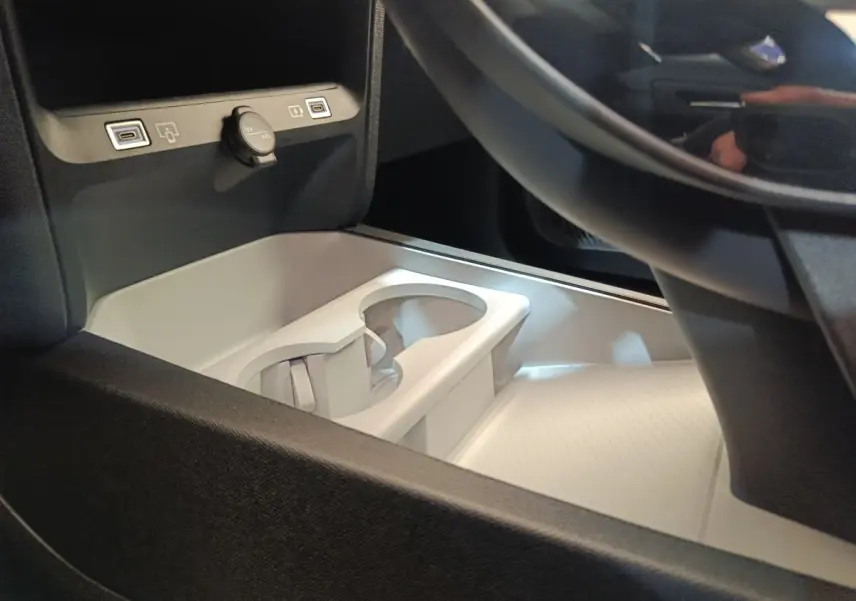 Gros plan intérieur sur la console centrale claire avec porte-gobelets et prises USB du Citroën C5 Hybride 2026.