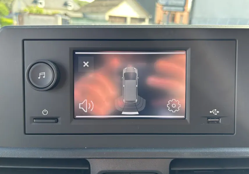 Écran tactile du tableau de bord du DANGEL Partner 4x4 affichant l'alerte de détection d'obstacle en vue de dessus.