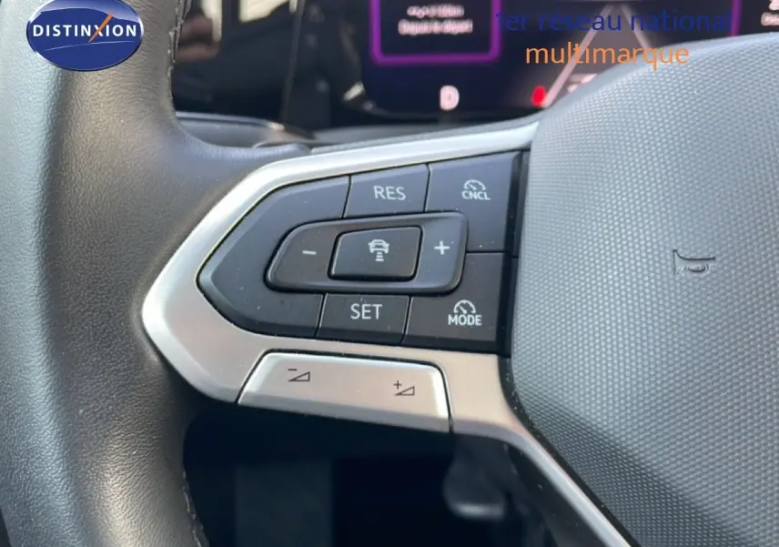 Gros plan sur les commandes de régulateur de vitesse au volant gris d’une Volkswagen Golf SW VIII 2024.