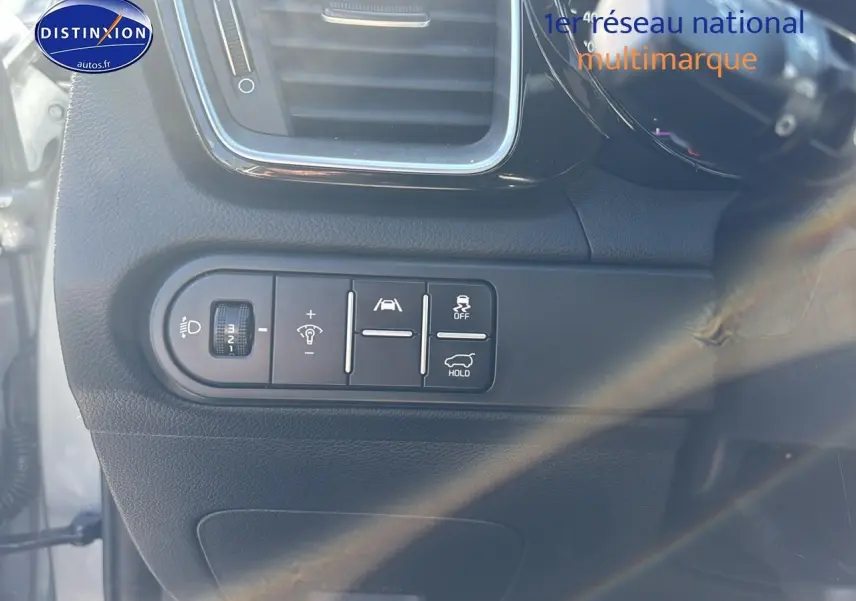 Vue intérieure côté gauche du tableau de bord gris foncé avec commandes d’éclairage et aides à la conduite du Kia Xceed 2024.