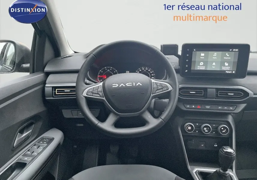 Vue intérieure frontale du poste de conduite du Dacia Jogger gris schiste, avec volant multifonction et écran tactile central.