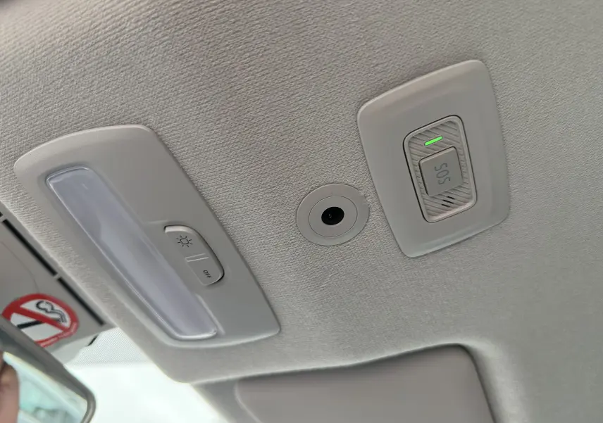 Plafonnier intérieur gris clair avec bouton d’éclairage et interrupteur SOS allumé dans une Dacia Sandero Stepway 2025.