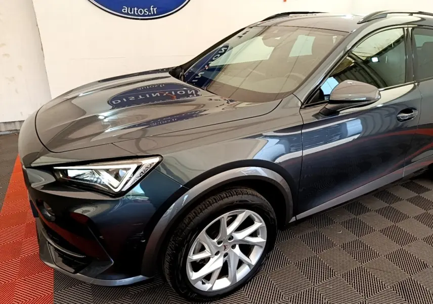 Vue 3/4 avant droit d'un CUPRA Formentor gris foncé avec jantes alliage et phares LED ellipsoïdaux.