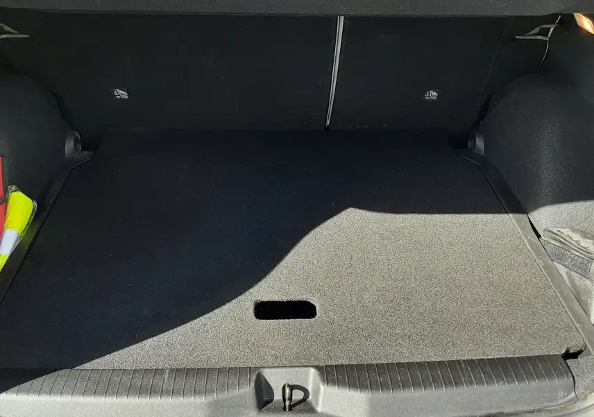 Coffre ouvert vu de l'arrière d'une Citroën C3 Aircross 2025 vert Montana avec intérieur noir et toit blanc.