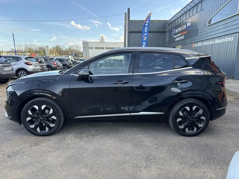 Vue latérale droite du KIA SPORTAGE noir Basalte métallisé, mettant en valeur ses jantes alliage et lignes modernes.