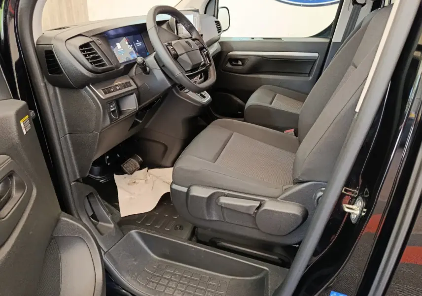 Vue intérieure côté conducteur du Peugeot Expert Fourgon XL noir 2026, sièges gris et tableau de bord moderne.
