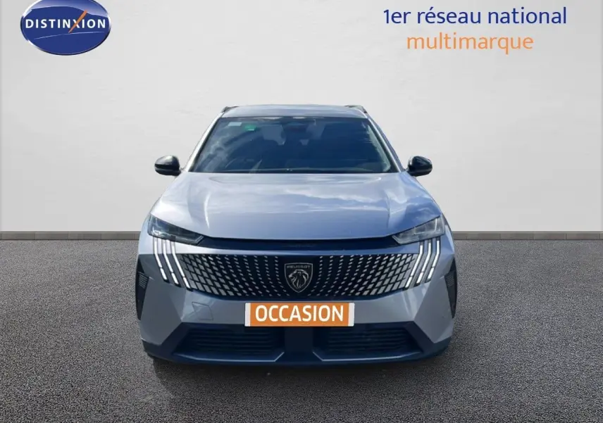 Vue avant d’un Peugeot 5008 gris Artense métal avec calandre distinctive et feux LED en forme de griffes.