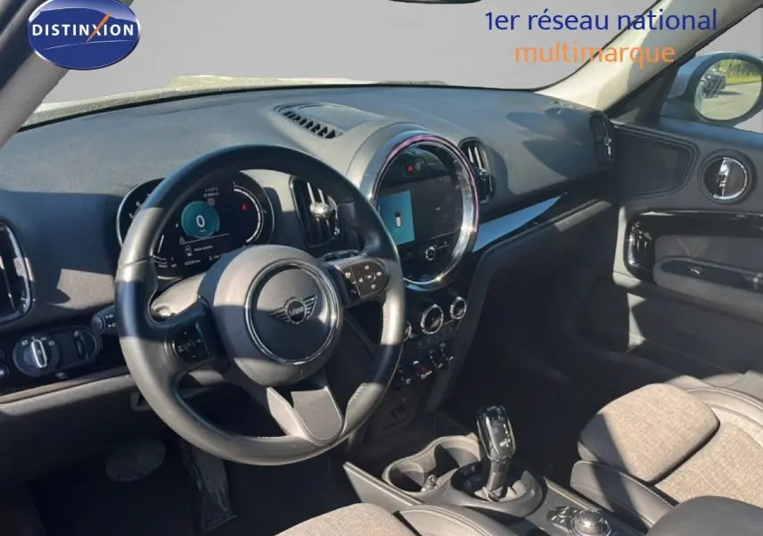 Vue intérieure côté conducteur du tableau de bord et volant noir d'une MINI Countryman 2023, ambiance moderne et épurée.