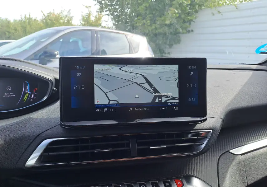 Vue intérieure du tableau de bord du Peugeot 3008 Hybrid 145 Allure Pack avec écran tactile de navigation et commandes climatisation.