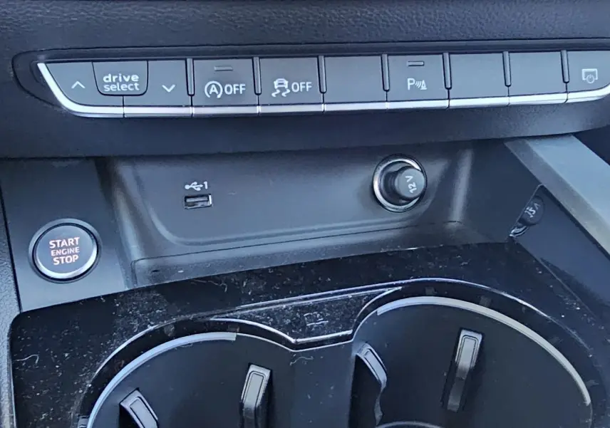 Gros plan sur la console centrale de l'Audi A5 Sportback 2022 avec boutons de contrôle et prise 12V visibles