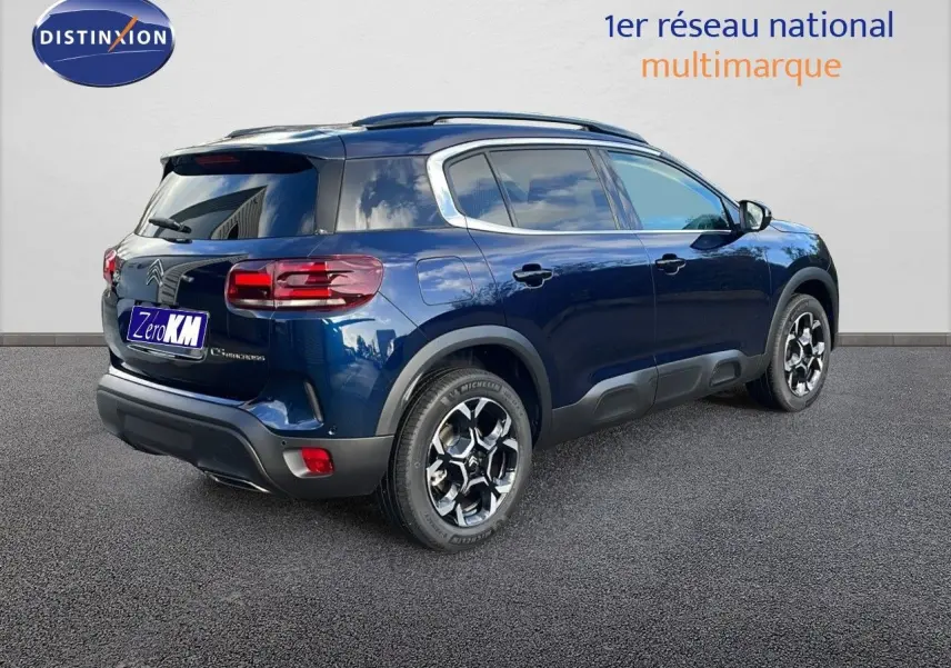 Citroën C5 Aircross bleu Eclipse métal en 3/4 arrière droit, avec jantes bicolores et protections noires.