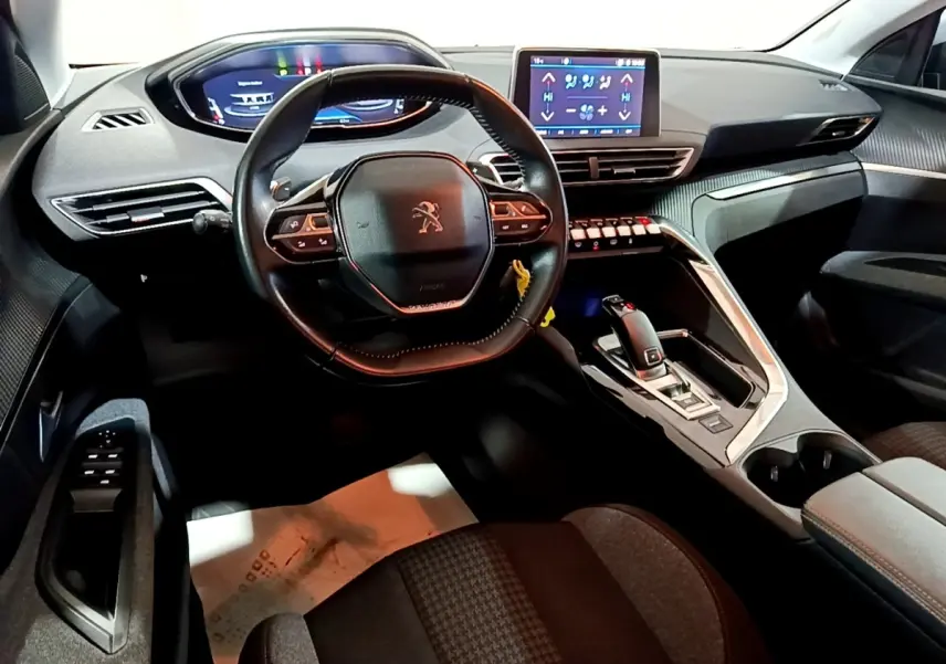 Vue intérieure avant du Peugeot 5008 2020, tableau de bord moderne avec écran tactile et volant cuir multifonctions.