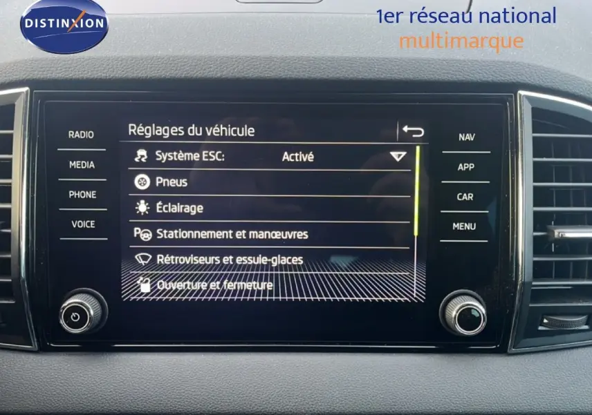 Écran tactile central du Skoda Karoq 2023 affichant les réglages du véhicule dans un intérieur sobre.