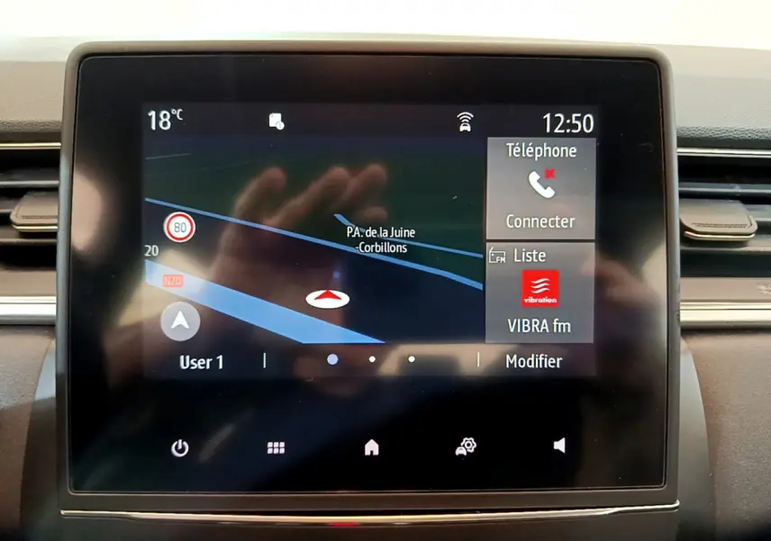 Écran tactile central du tableau de bord du Renault Captur Business Blue dCi 95 affichant la navigation et la radio.