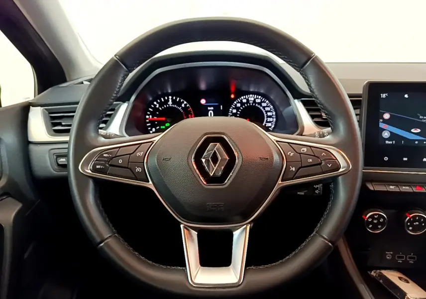 Vue rapprochée du volant noir de la Renault Captur 2020 avec tableau de bord et écran tactile à droite.