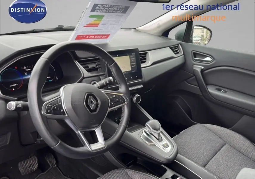 Vue intérieure côté conducteur du Renault Captur 1.6 E-TECH hybride, volant multifonction et console centrale avec boîte auto.