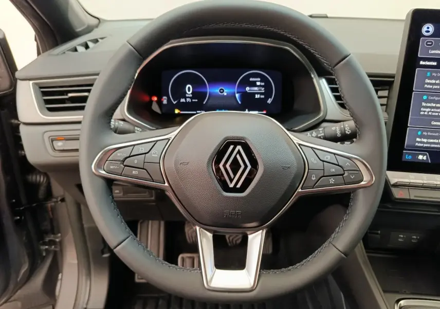 Vue rapprochée du volant noir de la Renault Captur 2025 avec tableau de bord numérique et écran tactile latéral.