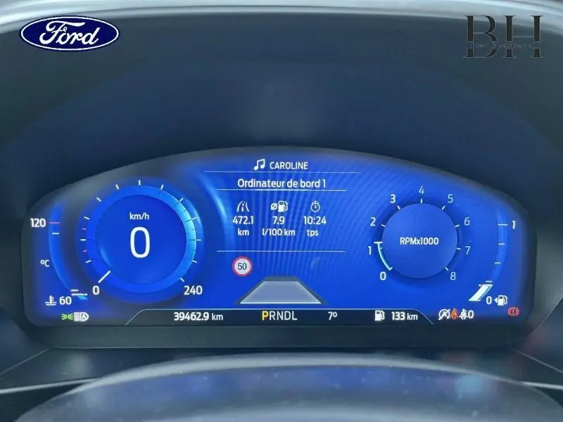 Vue rapprochée du tableau de bord numérique bleu de la Ford Focus SW 2024, affichant vitesse, compte-tours et informations de bord.