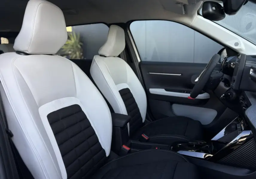 Vue intérieure côté droit du Citroën C3 Aircross 2025 avec sièges bicolores blanc et noir et tableau de bord moderne.