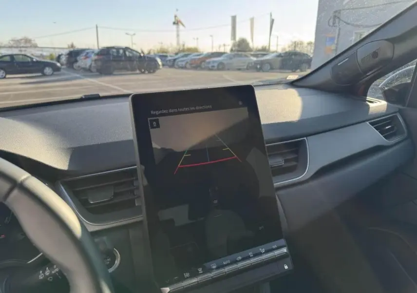 Vue intérieure du tableau de bord du Renault Captur II avec écran central tactile affichant la caméra de recul.