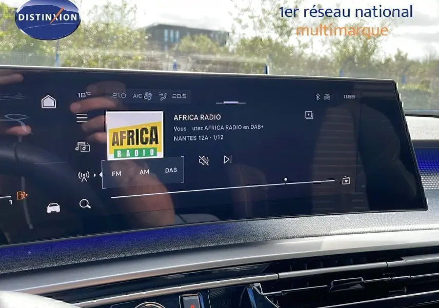 Écran tactile central affichant la radio Africa Radio dans le Peugeot 3008 hybride 2025, intérieur moderne et lumineux.