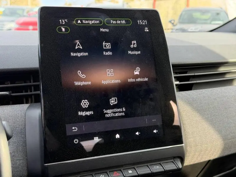 Écran tactile central de la Renault Clio 1.6 E-Tech 145ch gris Rafale, affichant le menu multimédia intérieur.