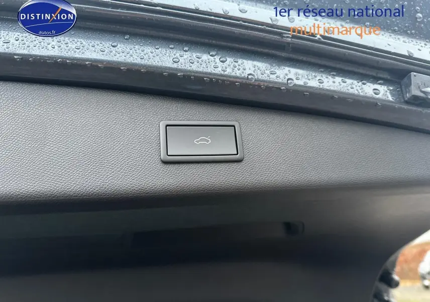 Bouton d'ouverture électrique du coffre sur le hayon intérieur d'une CUPRA LEON ST gris magnétique, vue rapprochée.