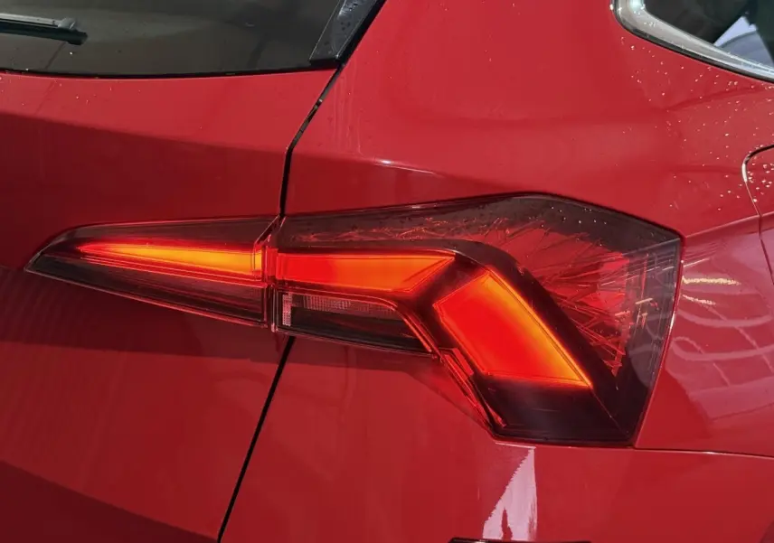 Gros plan sur le feu arrière droit rouge vif du SKODA KAMIQ 2024 avec détails lumineux nets et carrosserie brillante.