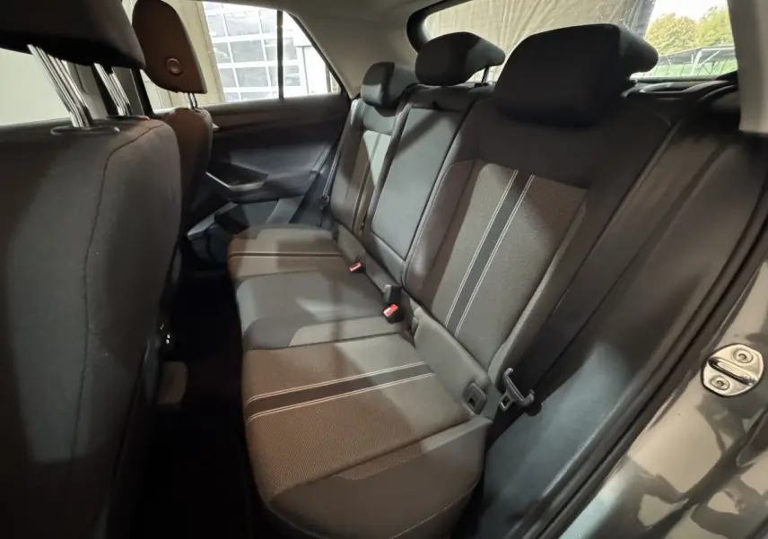 Vue intérieure côté droit des sièges arrière en tissu gris avec surpiqûres, dans un Volkswagen T-Roc gris foncé 2021.