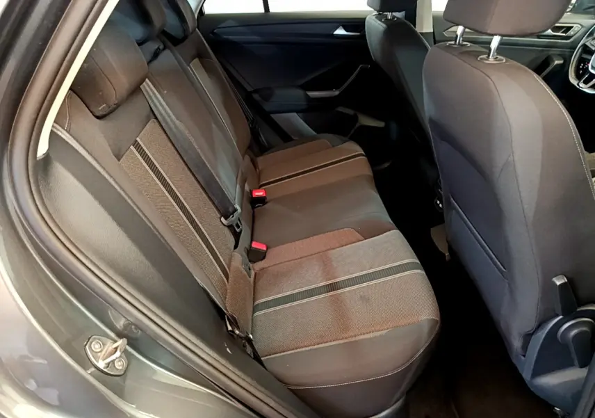 Vue intérieure côté gauche des sièges arrière gris foncé du Volkswagen T-Roc 2021 avec détails des ceintures et tissu.