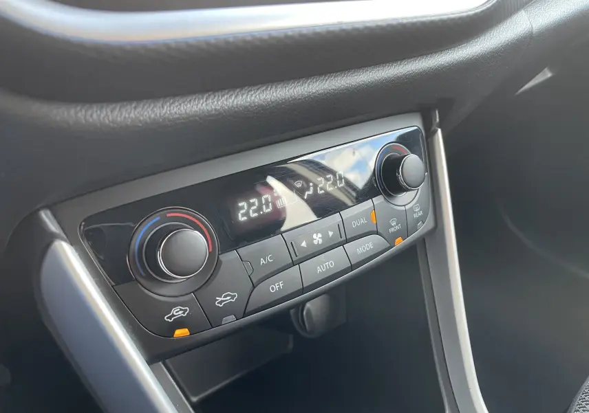 Gros plan sur la commande de climatisation automatique bi-zone du Suzuki SX4 S-CROSS gris, affichant 22°C.