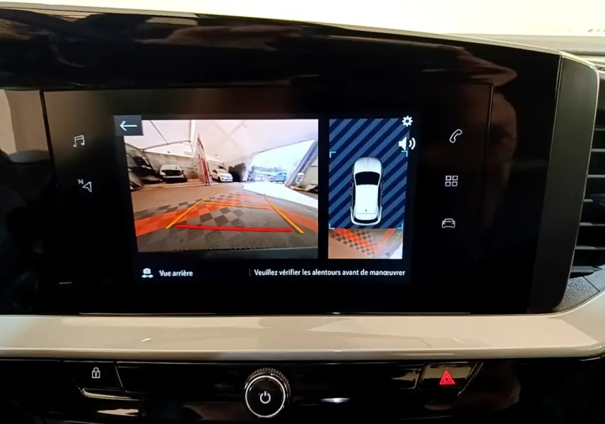 Écran tactile central affichant la caméra de recul et l'aide au stationnement du tableau de bord de l'Opel Mokka bleu.