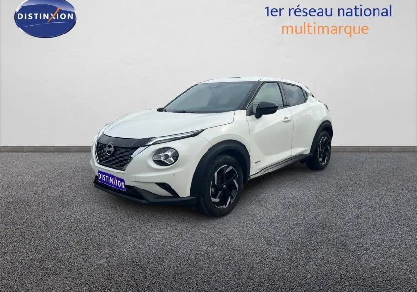 Nissan Juke blanc nacré métal vu en 3/4 avant droit, avec jantes noires et détails noirs contrastants.